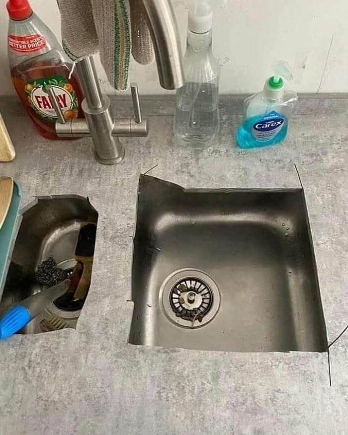 Kitchen sink cut out from countertop in a chaotic and funny way, combining trash and culture humorously.