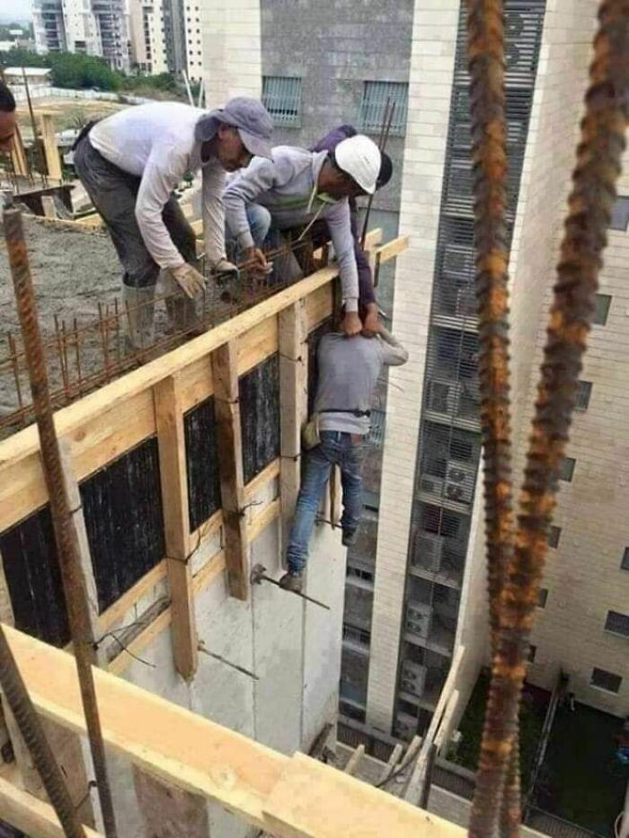 Construction workers making hilariously dumb mistakes on a high-rise building site despite engineering degrees.