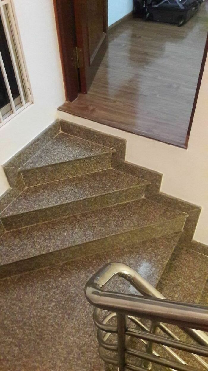 Stairs with a design flaw leading directly to a raised wooden floor, illustrating engineering mistakes.