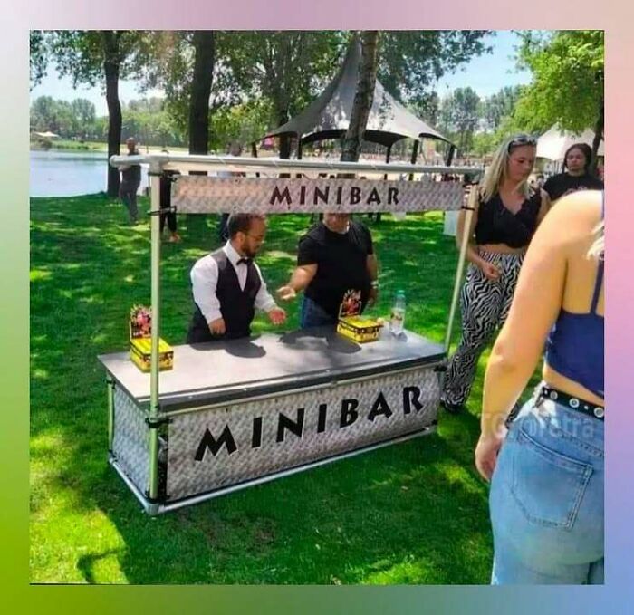 Mini bar setup outdoors with people, combining trash and culture in a chaotic and funny scene.