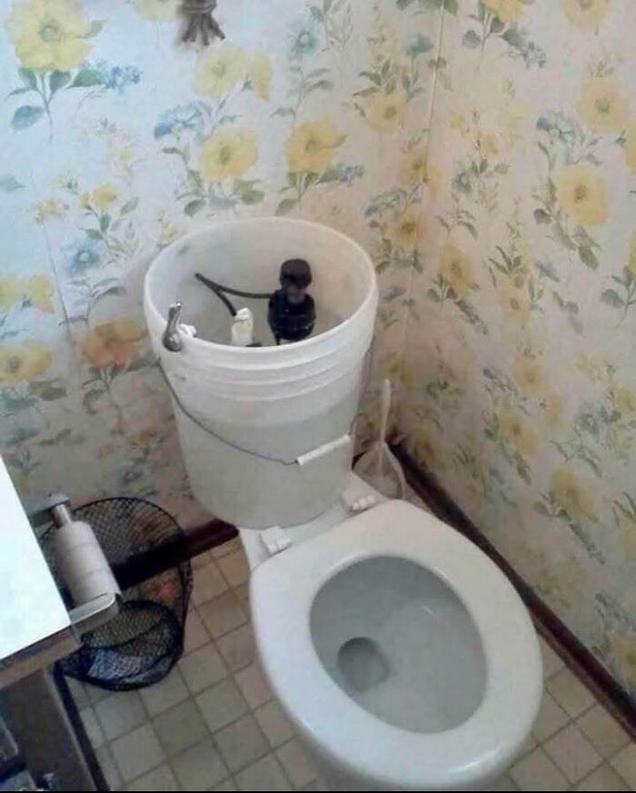 Toilet with bucket installed as a tank replacement, showcasing hilariously dumb engineering mistakes despite engineering degrees.