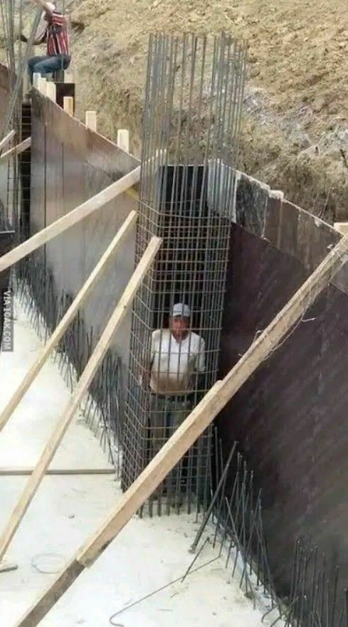 Man trapped inside steel rebar cage at construction site showing hilariously dumb engineering mistakes.