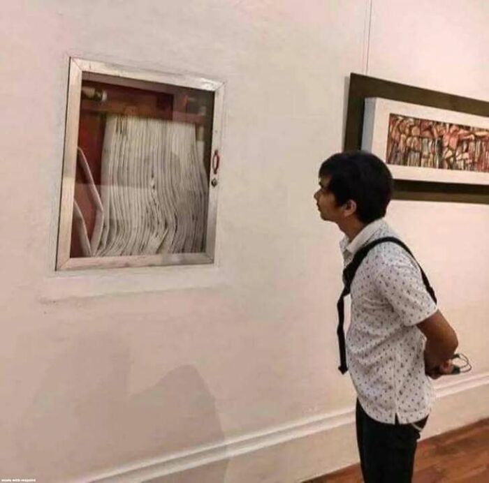 A man observing a framed piece of trash in an art gallery, blending trash and culture in a chaotic way.