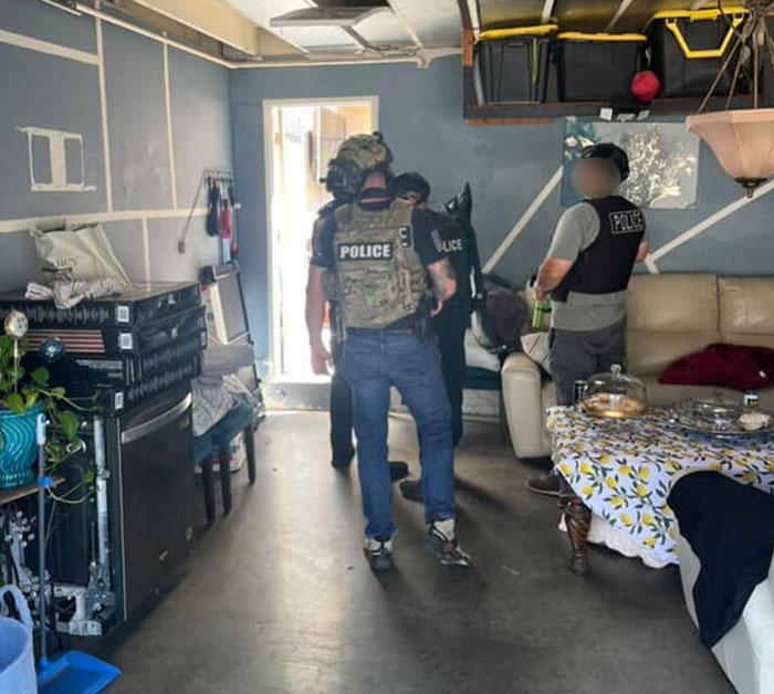 Police officers search inside a home during an investigation linked to an epic police fail in a high-profile case. - 3