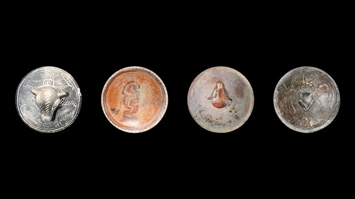 Ancient Maya royal tomb artifacts including silver and pottery bowls with intricate carvings and figures unearthed after 40 years of searching. - 13