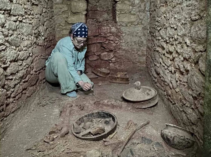 Archaeologist carefully excavating priceless artifacts inside a Maya royal tomb discovered by Texas couple after 40 years. - 4