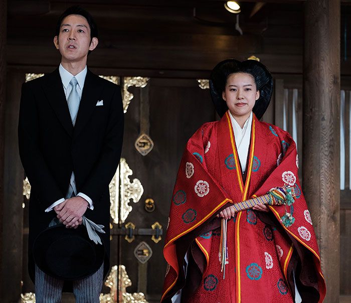 Traditional royal couple in formal attire standing indoors, illustrating royals who walked away from power for love and reasons.