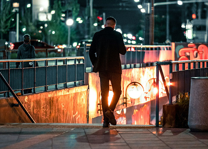 Private investigator walking alone at night in an urban area, capturing the essence of strange discoveries during investigations. - 3