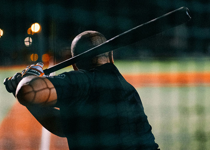 Private investigator holding a baseball bat at night, illustrating strange discoveries made during investigations. - 23