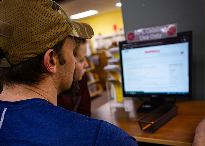 Private investigators researching strange things on a computer in a library, focusing on unusual discoveries during their job. - 17