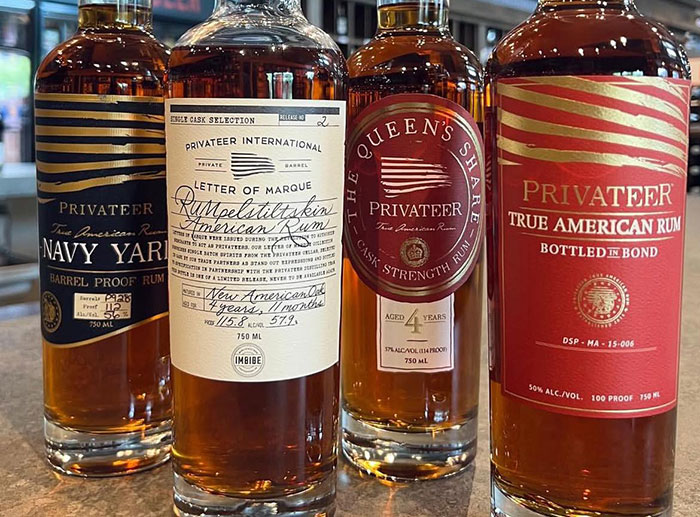 Bottles of Privateer rum on a bar counter, unrelated to Coldplay cheating scandal HR executive SEO keywords. - 4