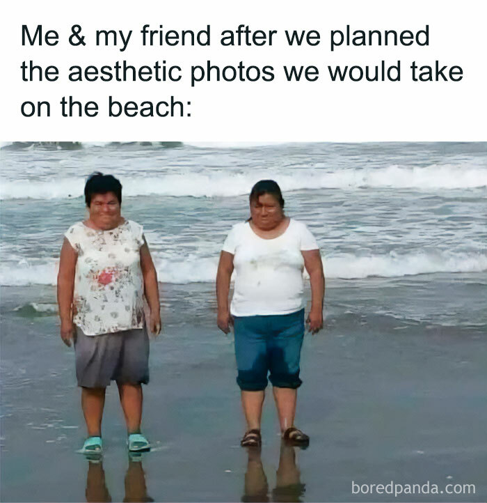 Two women standing awkwardly in wet clothes on the beach illustrating funny memes about not taking life seriously.