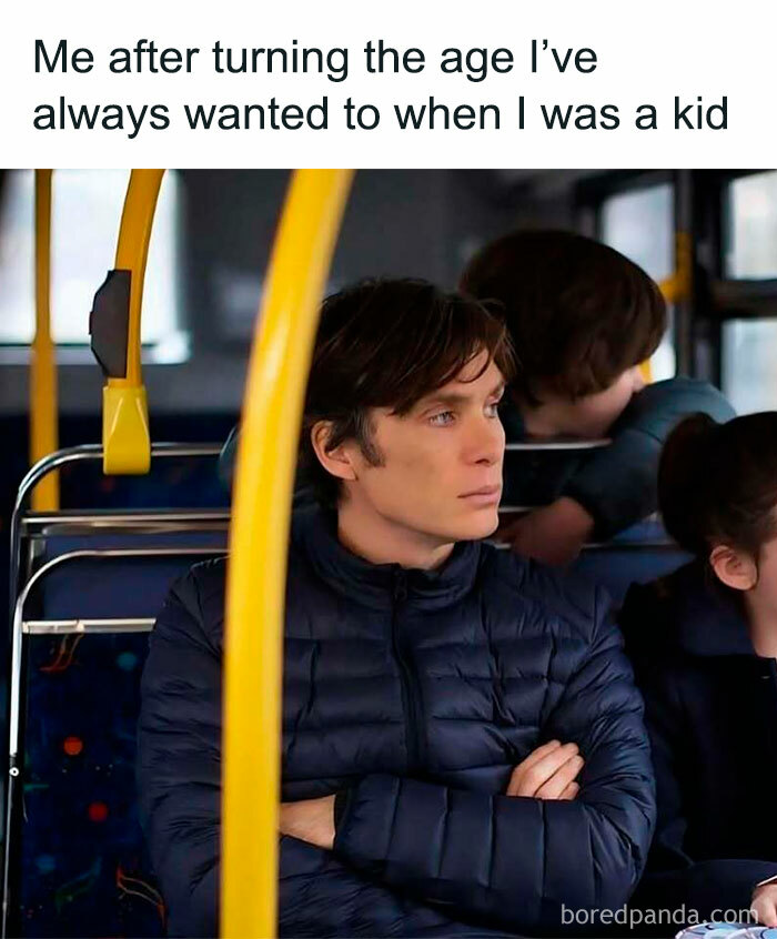 Young man sitting on a bus with a serious expression, reflecting funny memes about not taking life too seriously.