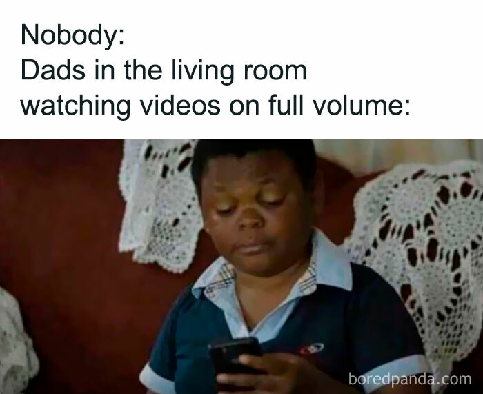 Boy looking at phone with a serious expression, illustrating funny and random memes about dads watching videos loudly.
