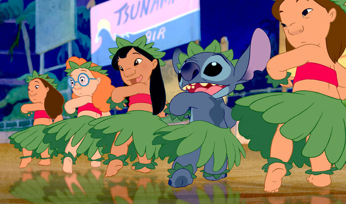 Stitch and friends in grass skirts performing a traditional dance in a scene from a popular Disney movie poll.