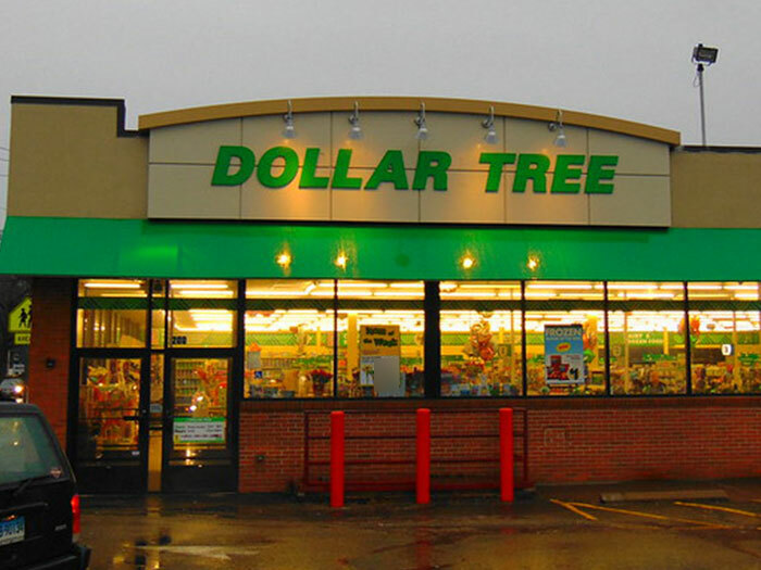 Dollar Tree store exterior at dusk with bright lights in a neighborhood showing signs to look out for unsafe areas.