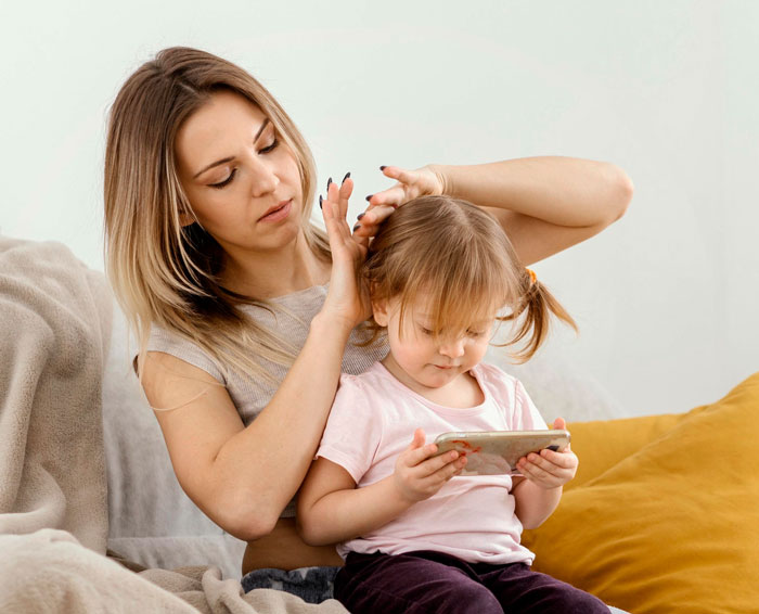 Teen refuses unpaid babysitting as young girl watches phone, showing family tension over babysitting and trip disagreement.