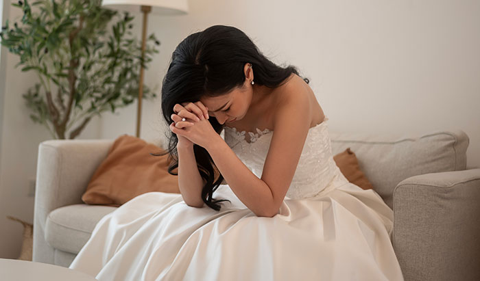 Bride in wedding dress sitting on couch upset after groom's parents call her self-centered brat for not kicking out autistic nephew Bride in wedding dress sitting on couch upset after groom's parents call her self-centered brat for not kicking out autistic nephew