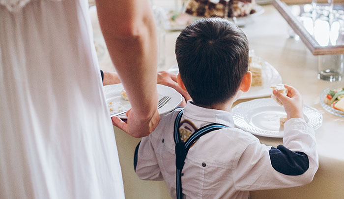 Bride standing next to autistic nephew at a wedding table, highlighting family conflict over inclusion and acceptance. Bride standing next to autistic nephew at a wedding table, highlighting family conflict over inclusion and acceptance.