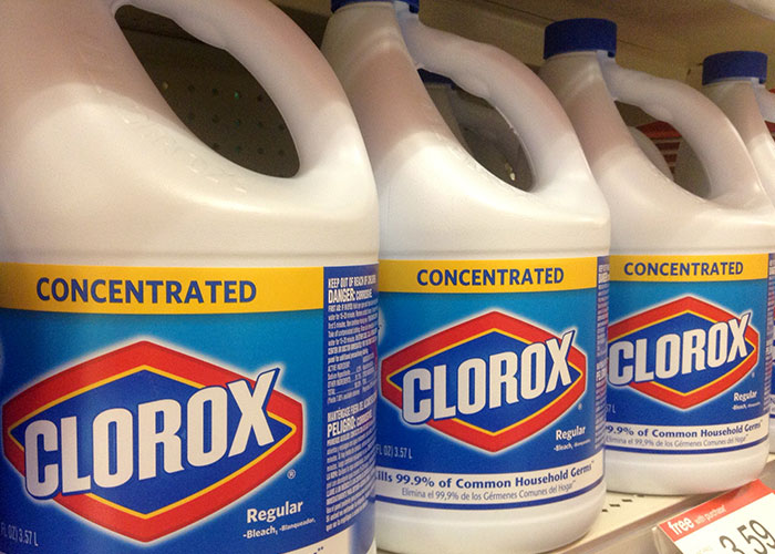Several bottles of concentrated Clorox bleach on a store shelf, a seemingly harmless but dangerous household item.