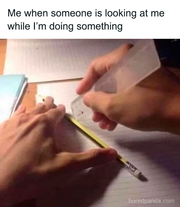 Person using a clear ruler to hide pencil while feeling anxious about being watched, illustrating social anxiety memes humor.