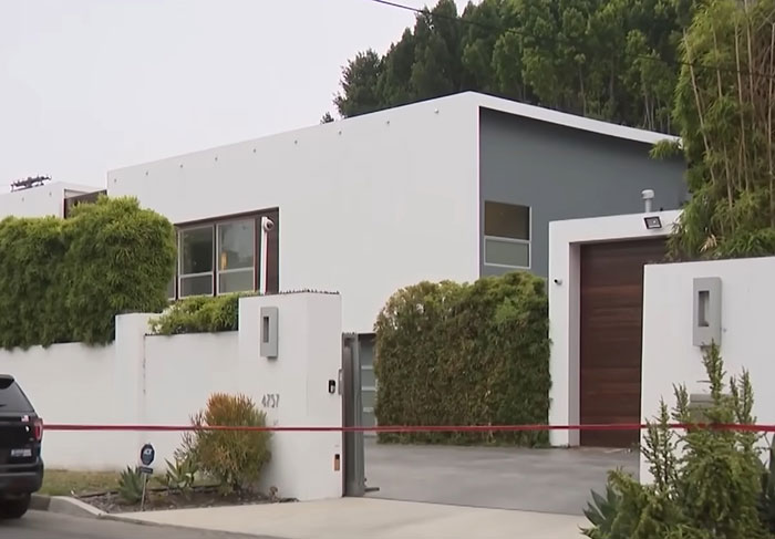 Modern residential home with police tape outside, related to epic police fail in discovering bodies after 911 call. - 2