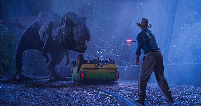 Tyrannosaurus rex confronting a man at night in a scene from Jurassic Park, highlighting dinosaurs disbelief conflict.