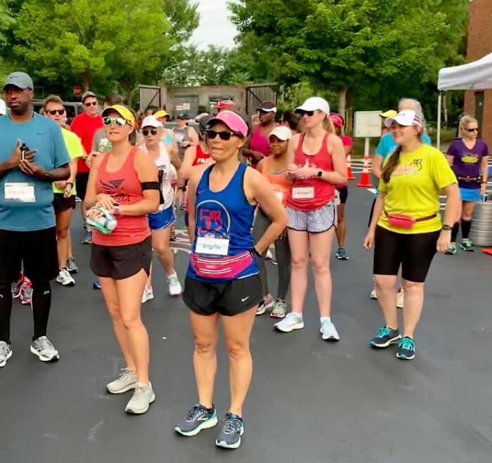 Group of diverse runners gathered outdoors preparing for a run, highlighting running as a way to overcome cancer and reclaim joy.