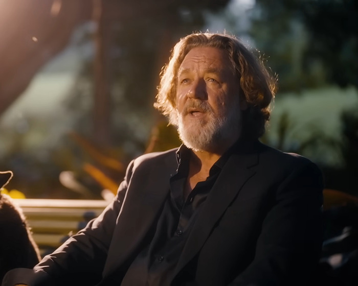 Russell Crowe wearing a dark suit with gray hair and beard, highlighting dramatic weight loss and Ozempic time outdoors. Russell Crowe wearing a dark suit with gray hair and beard, highlighting dramatic weight loss and Ozempic time outdoors.