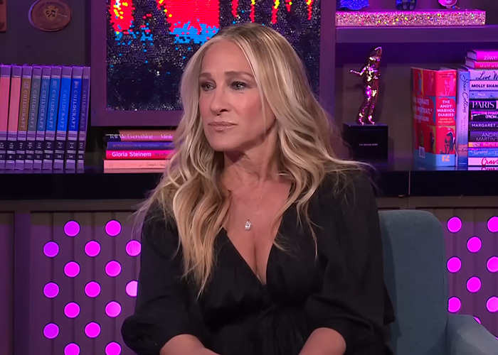 Sarah Jessica Parker with a perplexed expression during a talk show, highlighting her awkward reaction to Vogue cover news.