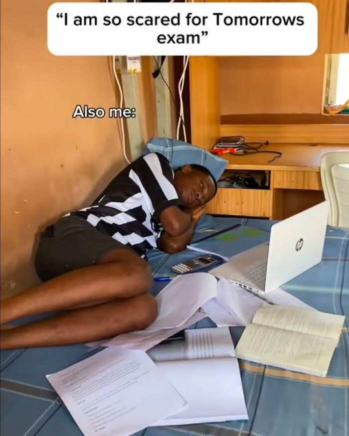 A student sleeping on a bed surrounded by open science books and a laptop, illustrating funny science memes.