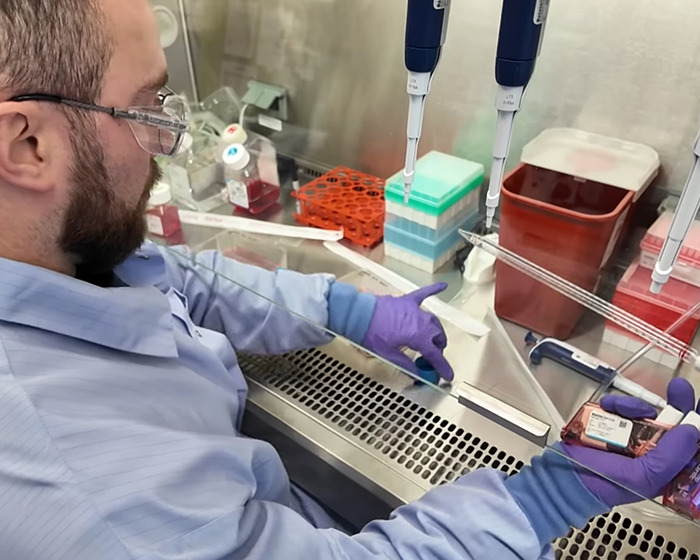 Scientist wearing blue gloves working with gene editing tools in a laboratory focused on curing Down Syndrome.