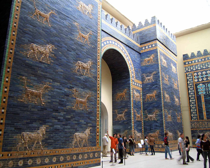 Ancient blue and gold brick wall with animal motifs in a museum, highlighting mysterious 3,000-year-old text on women's roles. Ancient blue and gold brick wall with animal motifs in a museum, highlighting mysterious 3,000-year-old text on women's roles.