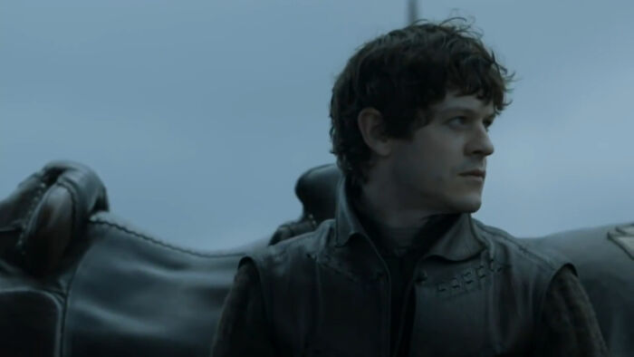 Actor portraying an iconic villain from a popular series, featured in a dark setting with moody lighting.