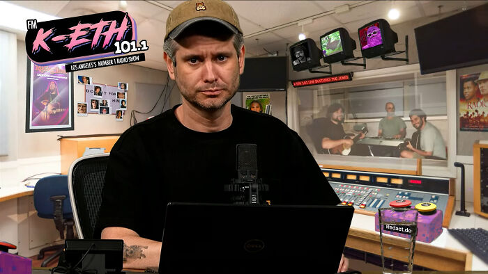 Man with cap and black shirt in a radio studio, people share opinions about unsubscribed YouTubers on air.