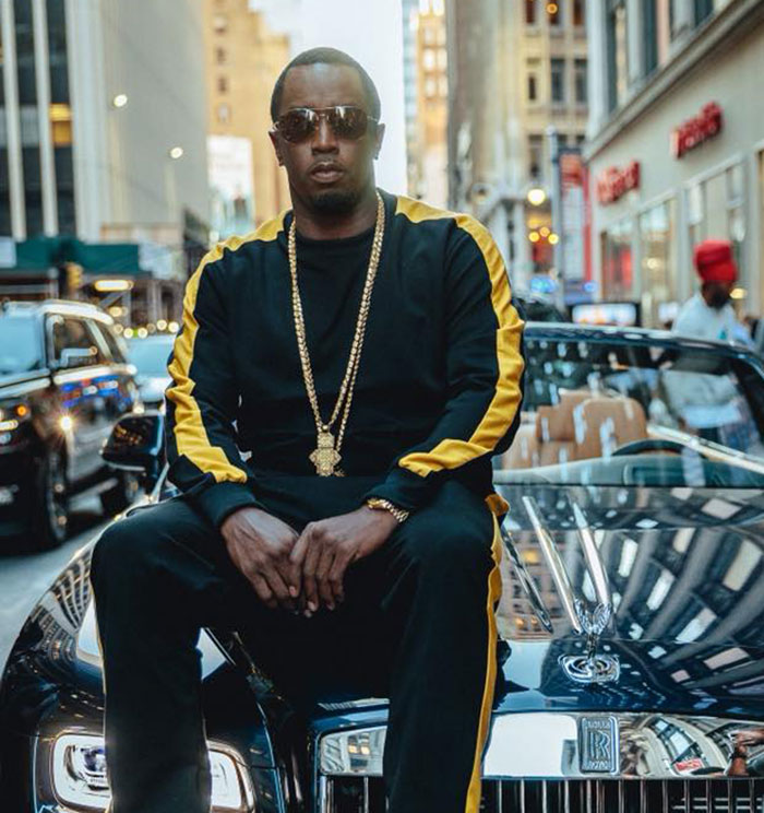 Diddy sitting on a luxury car in the city, representing Diddy's trial with surprising jury note after deliberations.