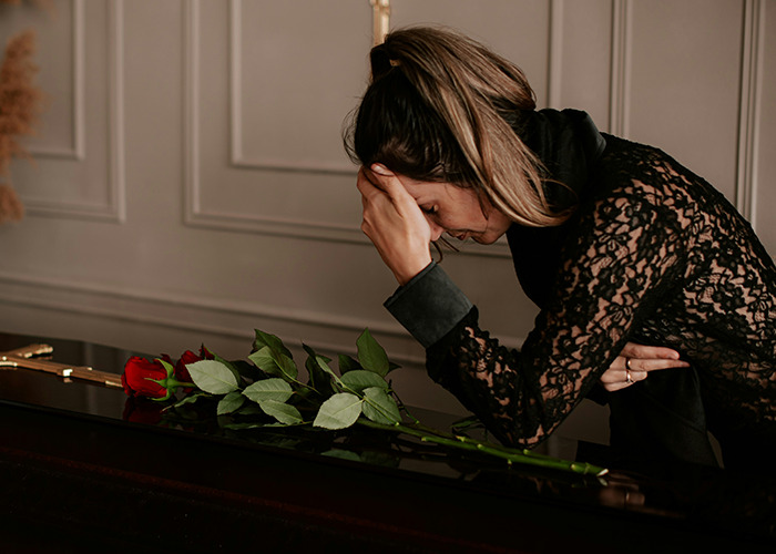 Woman in black lace top leaning on a piano with red roses, appearing distressed, symbolizing secrets people pray parents never find out. - 29