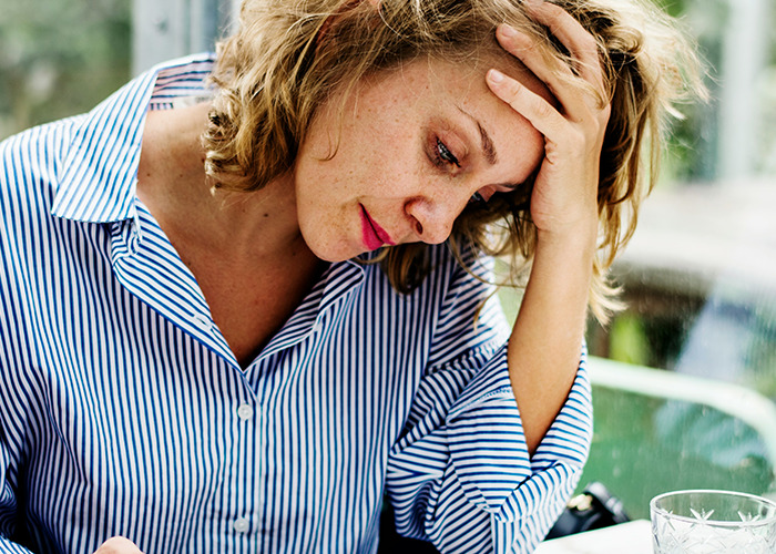 Young woman looking stressed and worried while sitting indoors, reflecting on secrets people pray their parents never find out. - 15
