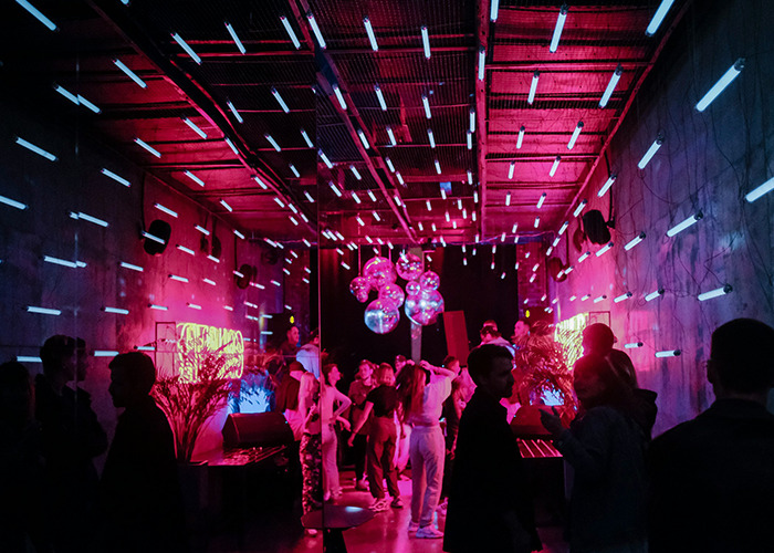 People socializing at a neon-lit party with reflective balloons, capturing secrets people pray their parents never find out. - 30