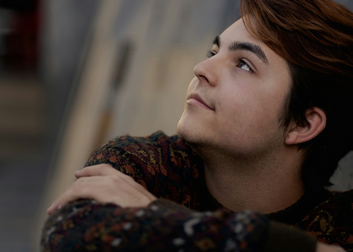 Young man looking up thoughtfully, reflecting on personal secrets people pray their parents never find out. - 3