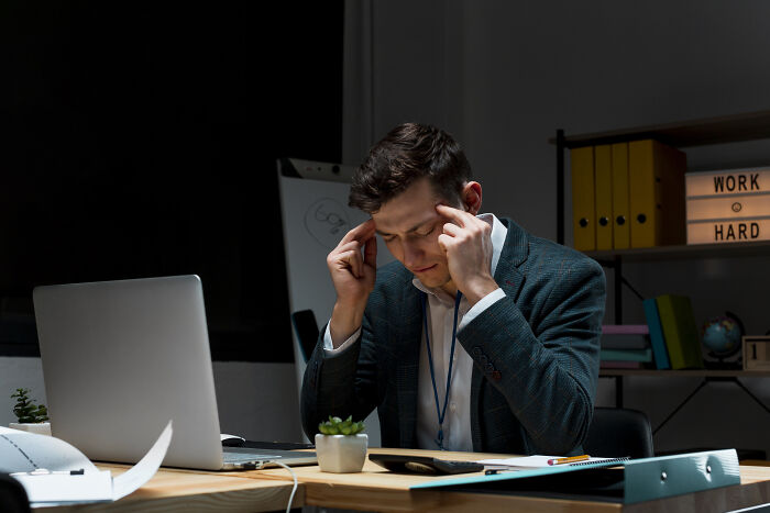 Man in office concentrating deeply with work documents, illustrating impact of sentences that changed people’s lives.