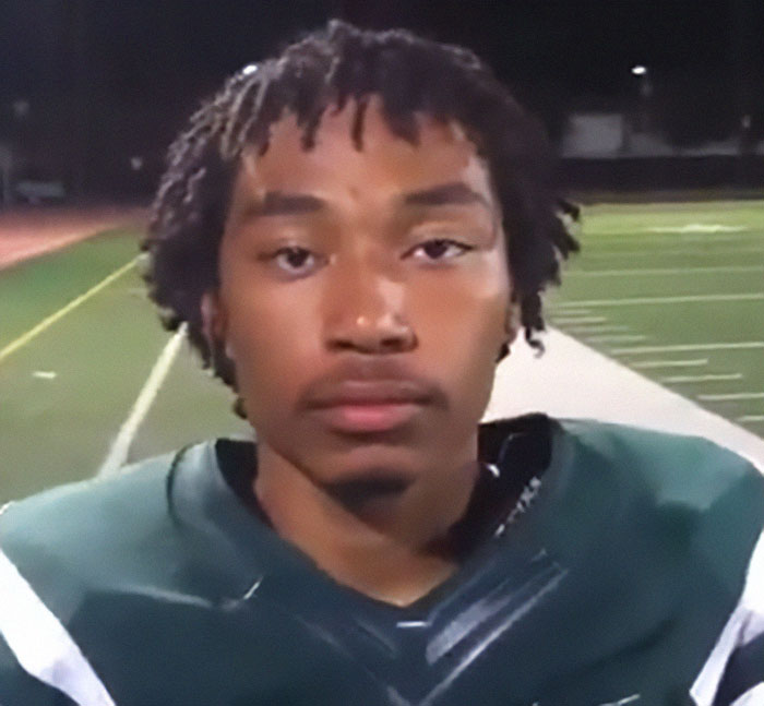 Young man in football gear standing on a field at night linked to chilling note about Manhattan massacre motive. - 14