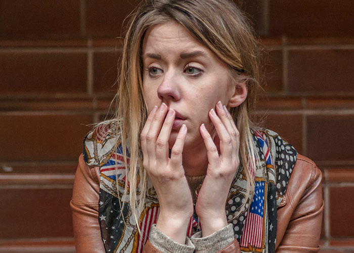 Young single woman looking worried and thoughtful, illustrating why many single women avoid men like the plague.