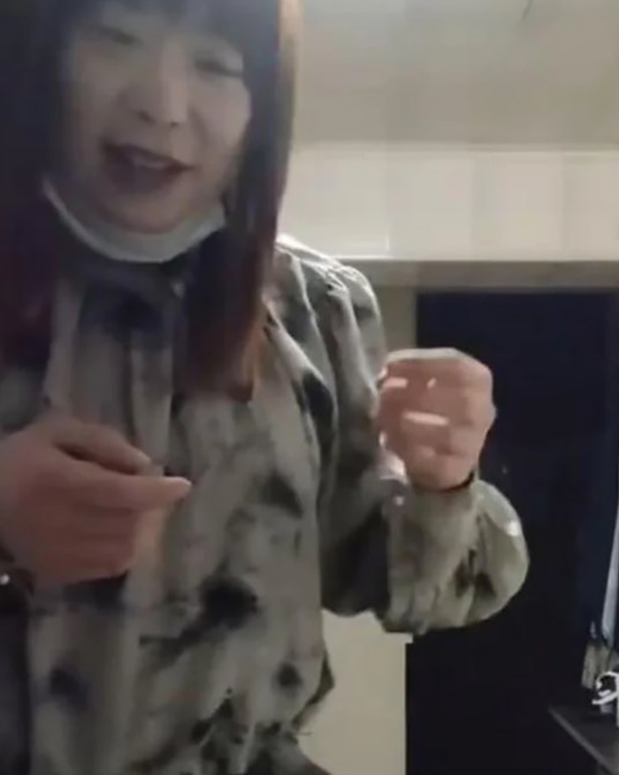 Person in a tie-dye shirt posing indoors, linked to viral predator Sister Hong secretly filming intimate encounters.