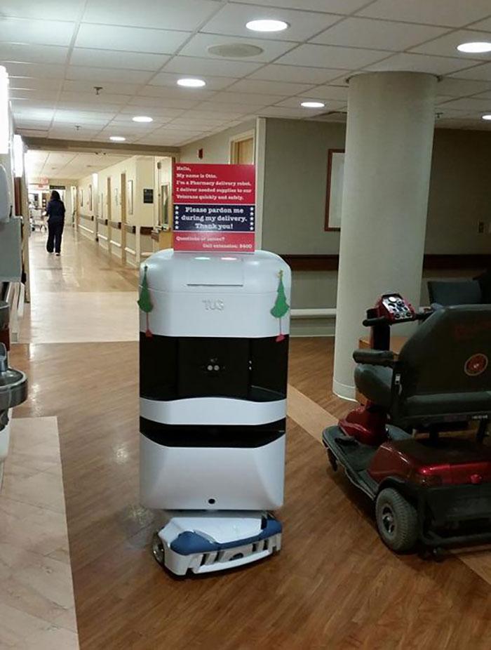 Autonomous pharmacy delivery robot navigating hospital hallway offering genius solutions to overlooked problems.
