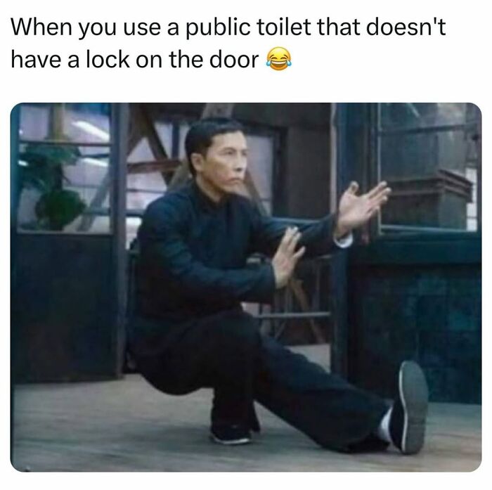 Man in black outfit cautiously balancing with one leg stretched out, illustrating a chaotic meme about public toilet lock struggles.