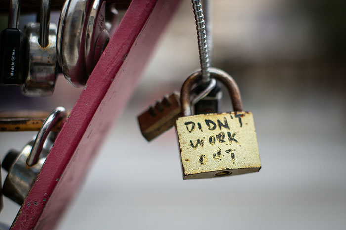 Close-up of a weathered lock with the words didn't work symbolizing a wife’s affair partner crash and divorce delay request. - 1