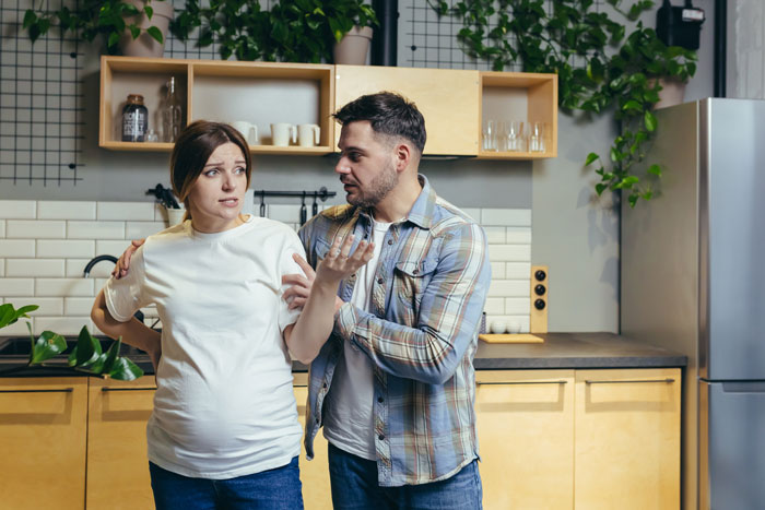 Woman looking upset while man tries to explain in a kitchen, depicting toxic family refusing to reconnect after betrayal - 26