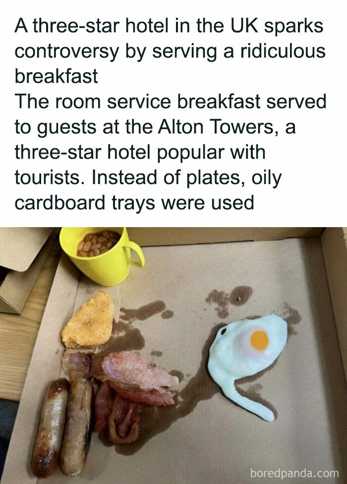 Unholy meal served on oily cardboard tray with sausage, bacon, egg, hash brown, and baked beans in a yellow mug.