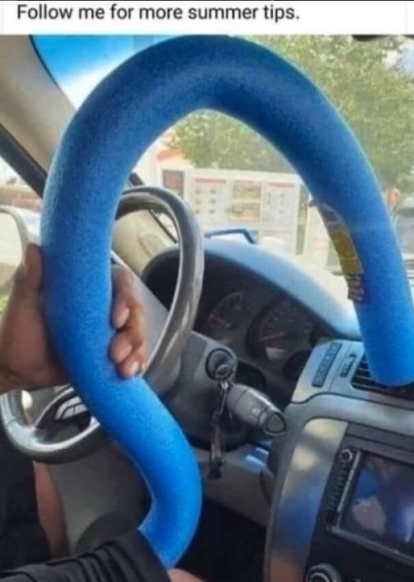 Man holding a blue pool noodle shaped like a steering wheel inside a car, funny summer memes concept